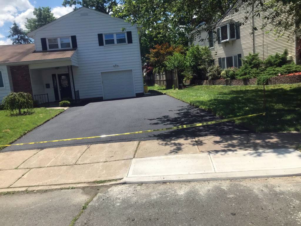 New asphalt driveway with a clean apron