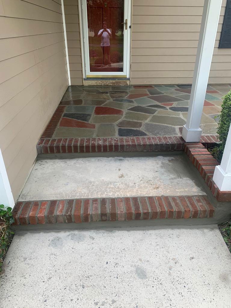Brick front steps with a flagstone landing